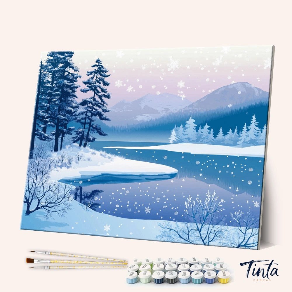 Angled view of Winter Whisper Lake paint by numbers kit featuring snowy trees and frozen lake at dusk by Tinta Canvas